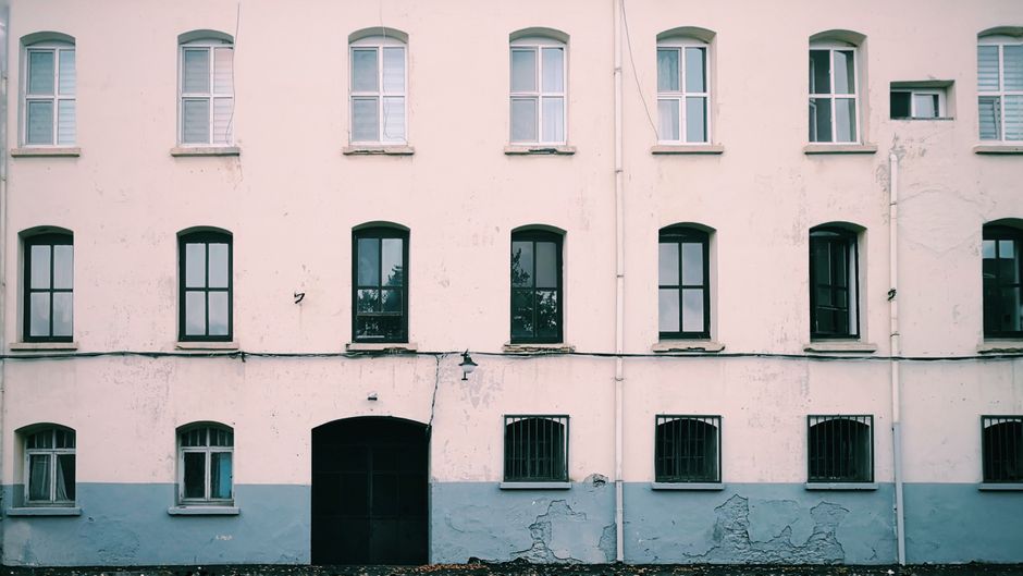 Front view of a painted house facade with symmetrical windows.